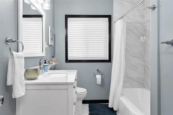 a view of backyard with swimming pool and furniture