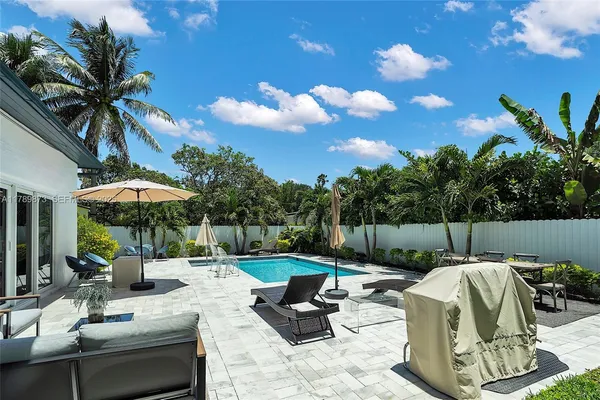 a view of a house with backyard sitting area and garden