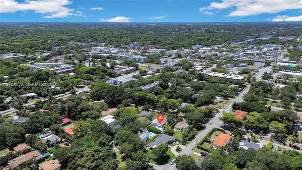 an aerial view of residential houses with city view