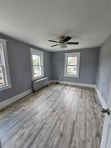 wooden floor in an empty room with a window