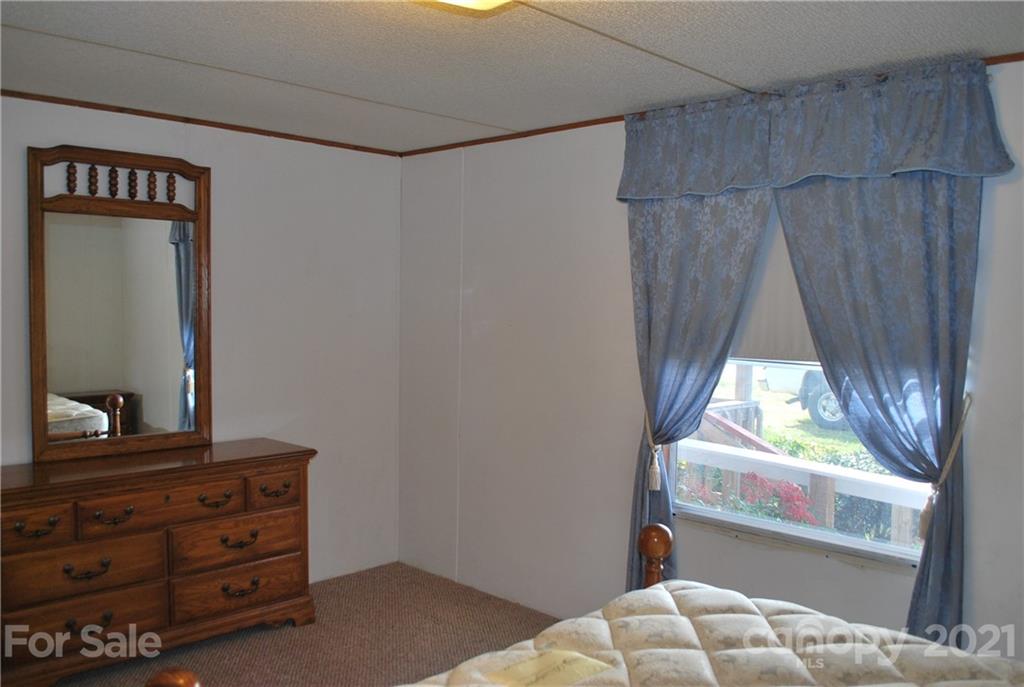 378 Phillipsville Loop Canton, NC 28716 - Photo 14 of 32 a bedroom with a bed and a dresser