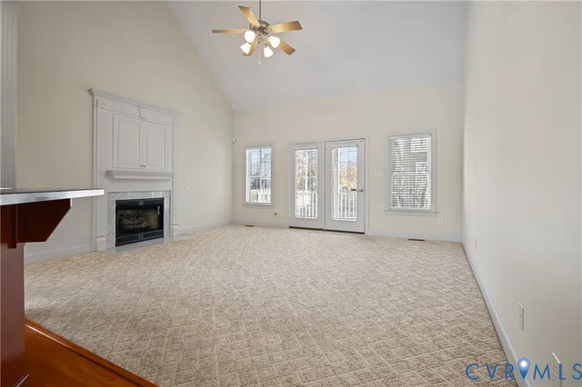 a view of an empty room with a fireplace and a window