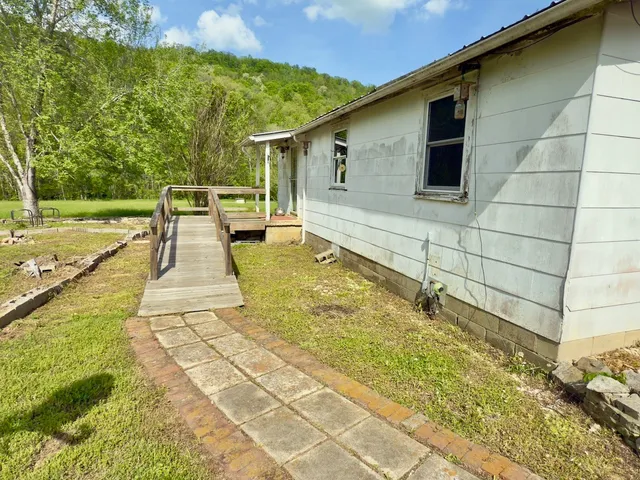 a dining room with furniture a chandelier and wooden floor