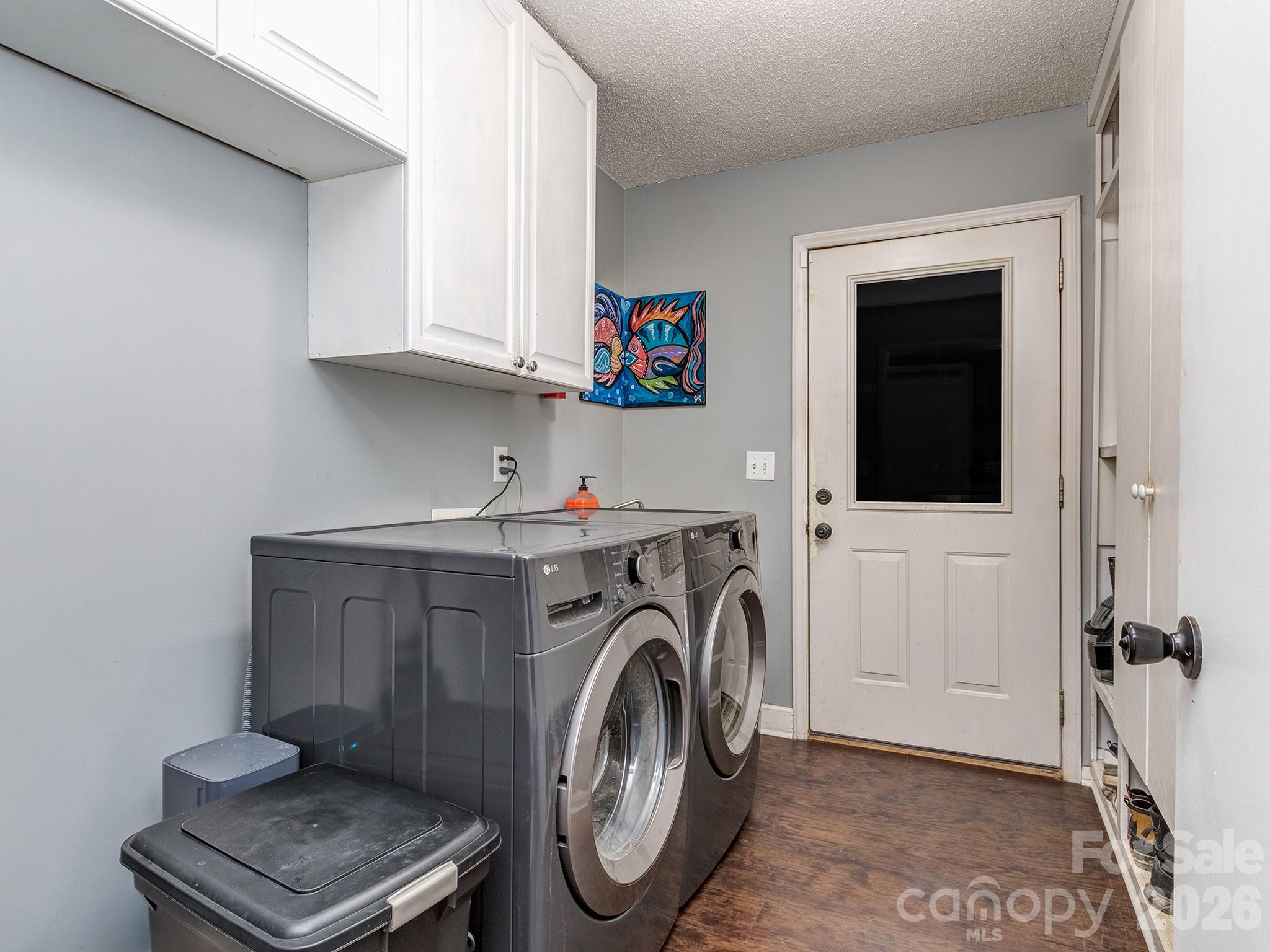 8723 Crestview Road Waxhaw, NC 28173 - Photo 14 of 33 a utility room with dryer washer and a view of kitchen