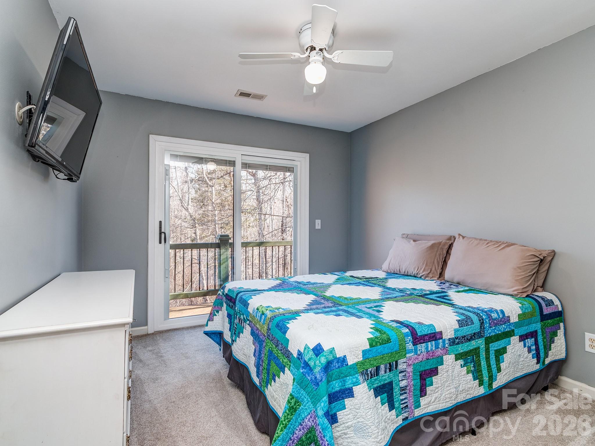 8723 Crestview Road Waxhaw, NC 28173 - Photo 18 of 33 a bedroom with a bed a chandelier and a chair