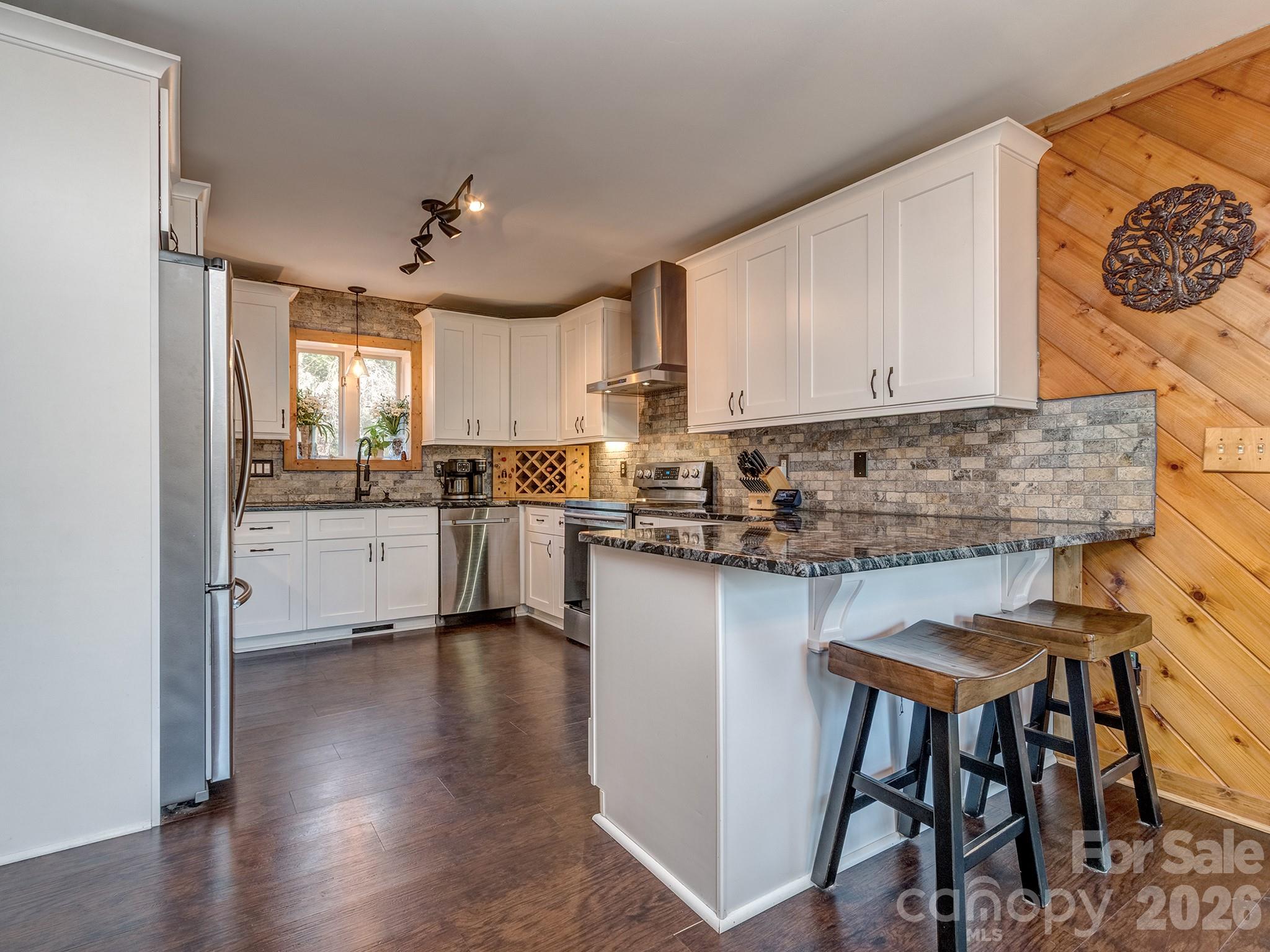8723 Crestview Road Waxhaw, NC 28173 - Photo 8 of 33 a kitchen with granite countertop white cabinets and stainless steel appliances