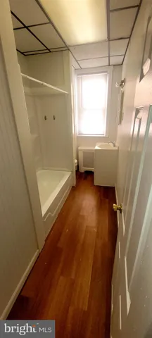 a bathroom with a tub and window