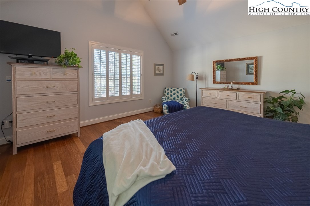 158 Northview Ridge Glade Valley, NC 28627 - Photo 18 of 27 a bedroom with a bed and flat screen tv