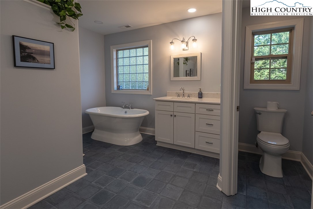 158 Northview Ridge Glade Valley, NC 28627 - Photo 19 of 27 a bathroom with a toilet sink and mirror