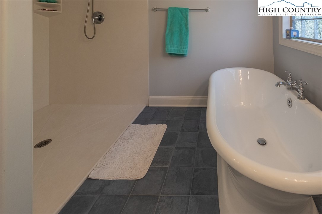 158 Northview Ridge Glade Valley, NC 28627 - Photo 20 of 27 a bathroom with a white bath tub and a shower curtain