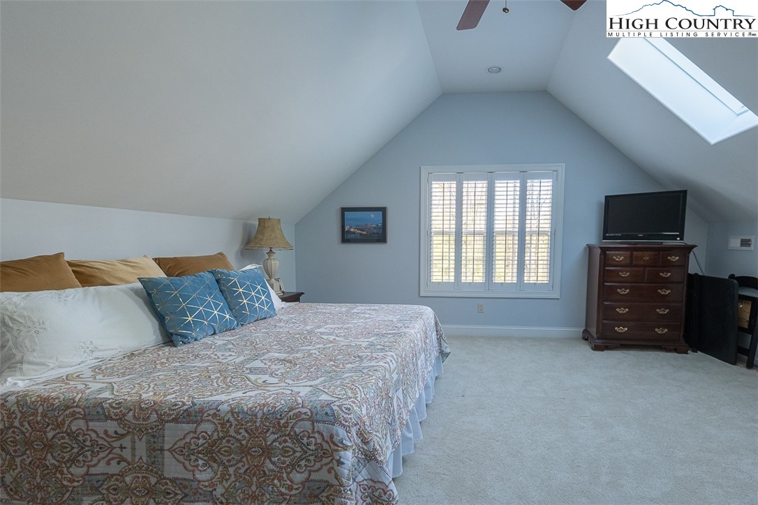 158 Northview Ridge Glade Valley, NC 28627 - Photo 24 of 27 a spacious bedroom with a bed and a television
