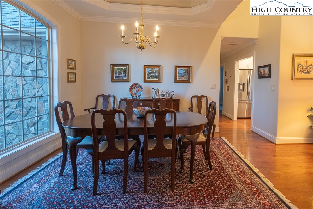 158 Northview Ridge Glade Valley, NC 28627 - Photo 6 of 27 a view of a dining room with furniture wooden floor and a chandelier