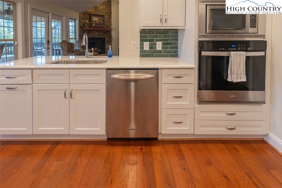 158 Northview Ridge Glade Valley, NC 28627 - Photo 9 of 27 a kitchen with granite countertop white cabinets and stainless steel appliances