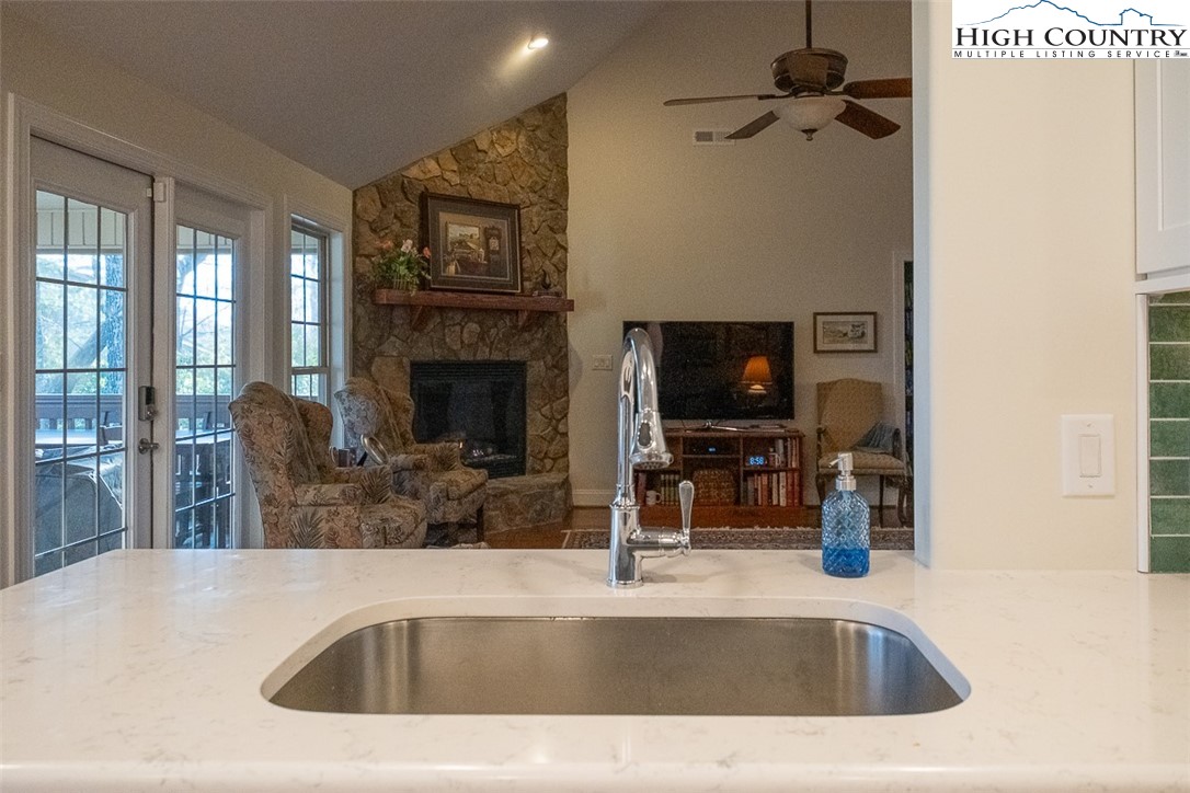 158 Northview Ridge Glade Valley, NC 28627 - Photo 10 of 27 a kitchen with a sink a counter top space and a fireplace
