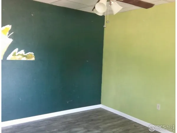 a view of a hallway with a chandelier fan and wooden floor