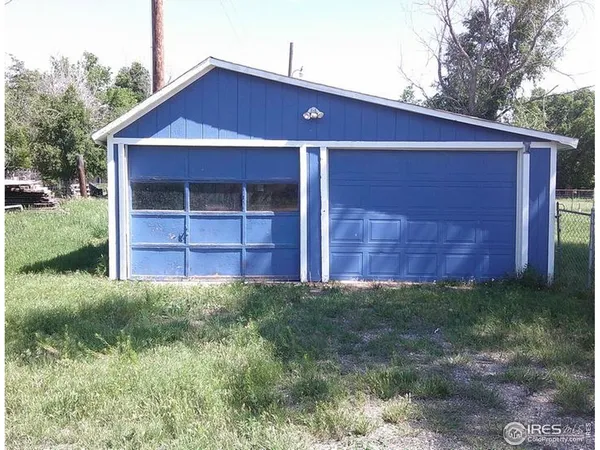 a front view of a house with yard and green space