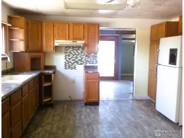a kitchen with a refrigerator and cabinets