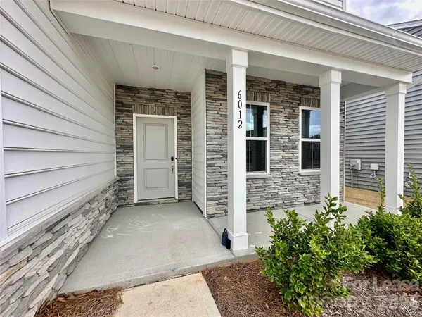 a view of front door of house with stairs