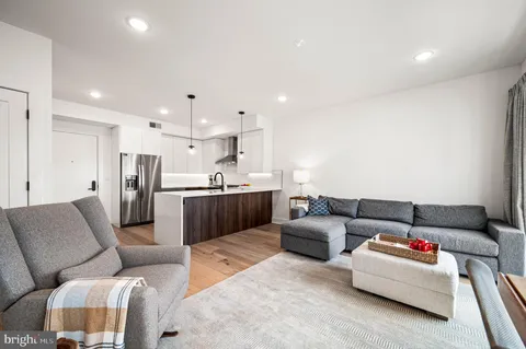 a living room with furniture and kitchen view