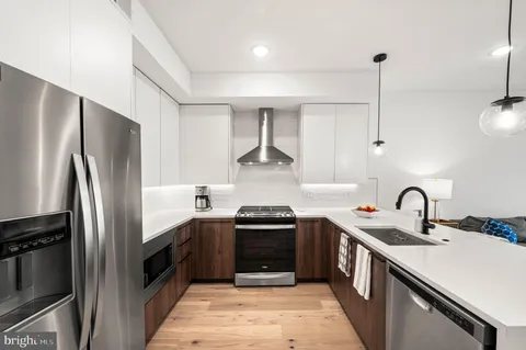 a kitchen with a sink stainless steel appliances and cabinets