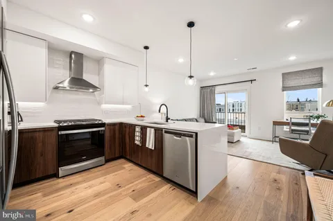 a kitchen with stainless steel appliances a stove sink and cabinets