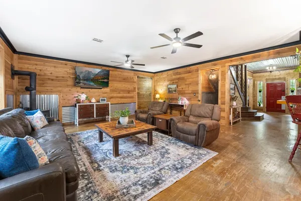 a living room with fireplace furniture and a large window