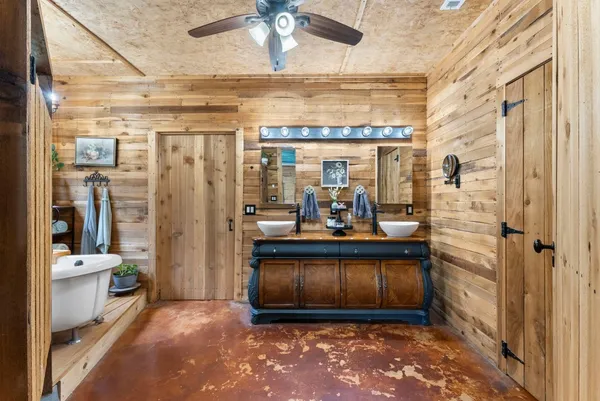 a view of a bathroom with tub and shower