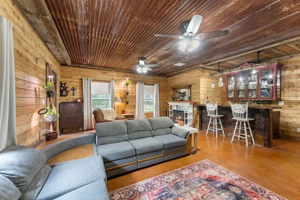 a living room with furniture and a fireplace