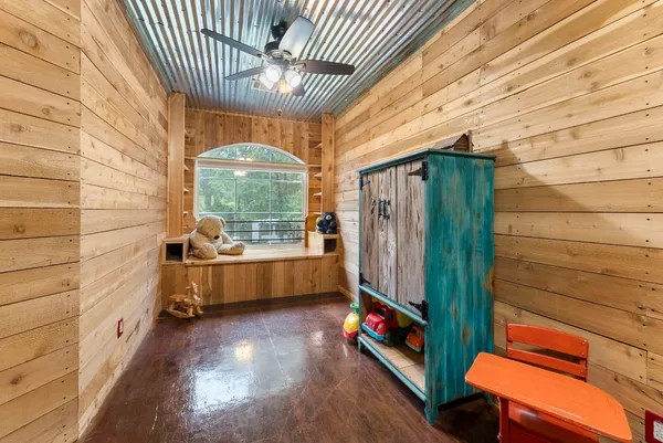a living room with furniture a fireplace and wooden floor