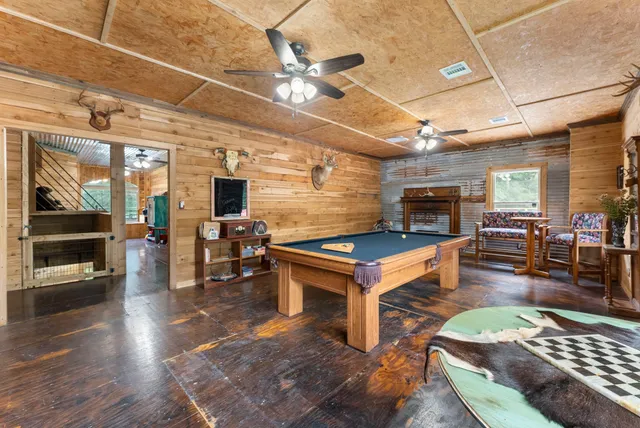 a spacious bedroom with a bed a table and windows