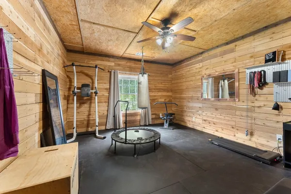 a spacious bedroom with a bed and a chandelier