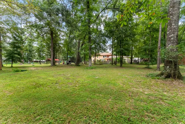 a view of a patio with a table and chairs under an umbrella