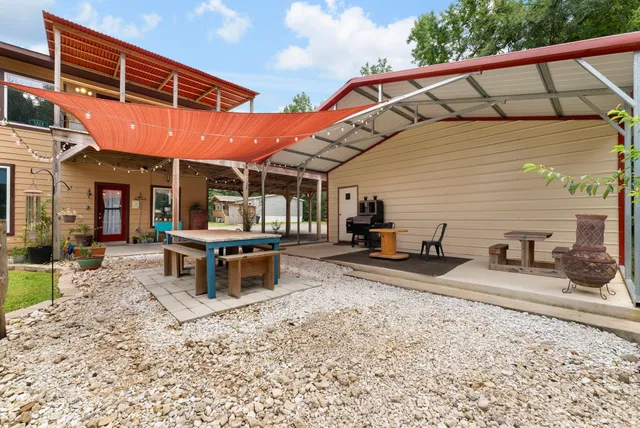 an aerial view of a house with swimming pool and big yard