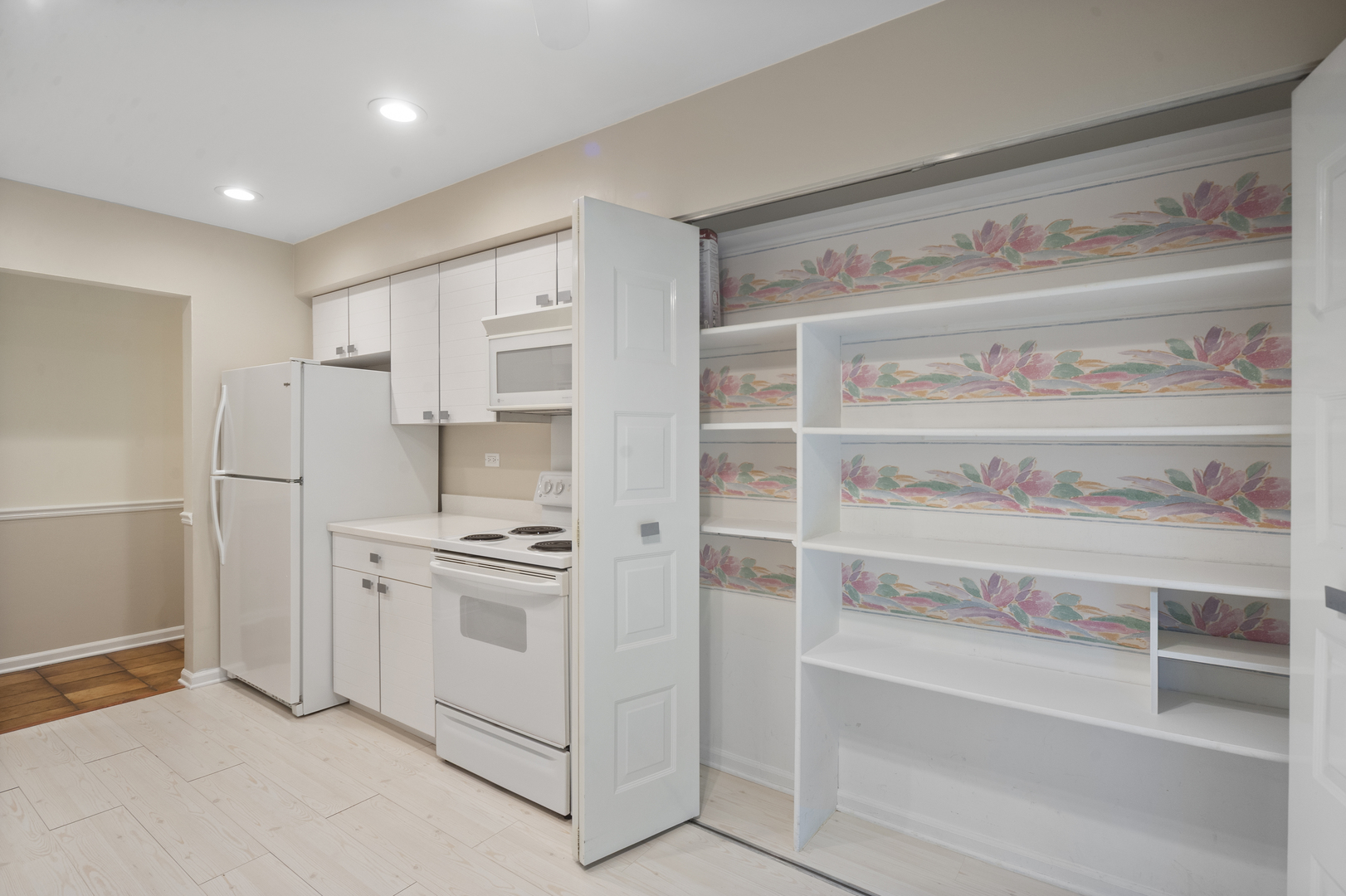 4949 Golf Road, Unit 101 Skokie, IL 60077 - Photo 9 of 22 a kitchen with white cabinets and white appliances