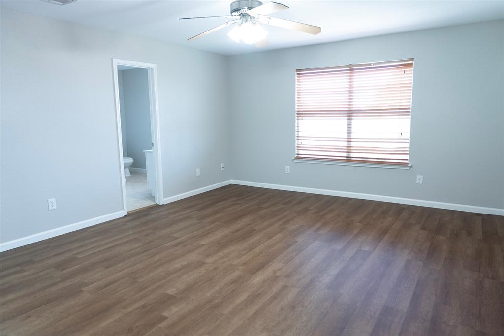 8805 Graywolf Ridge Trail Fort Worth, TX 76244 - Photo 13 of 23 Spacious interior with wood-finish flooring, a ceiling fan, and a window with blinds