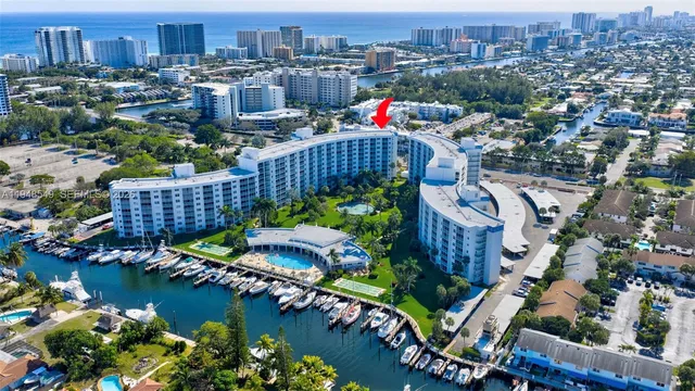 an aerial view of a house with a garden and lake view