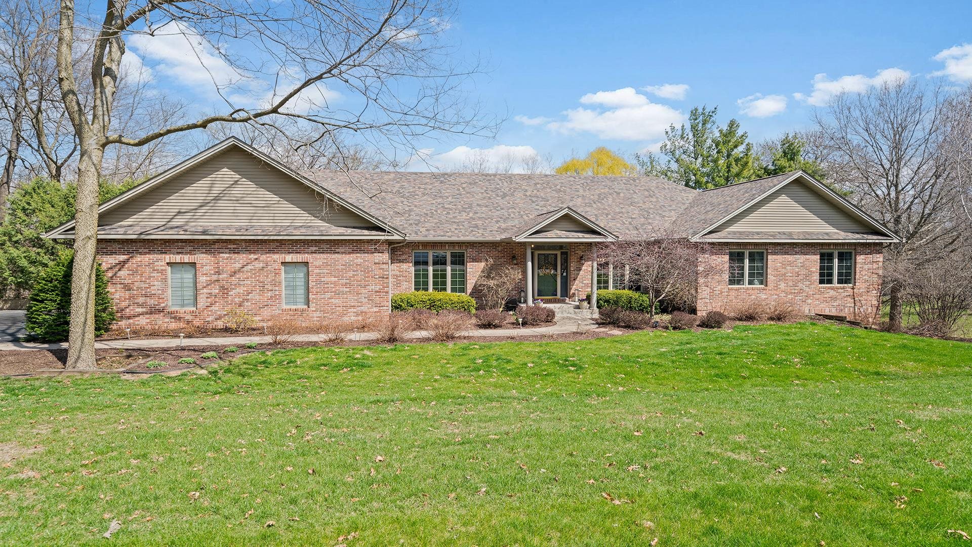 a front view of a house with a garden and patio