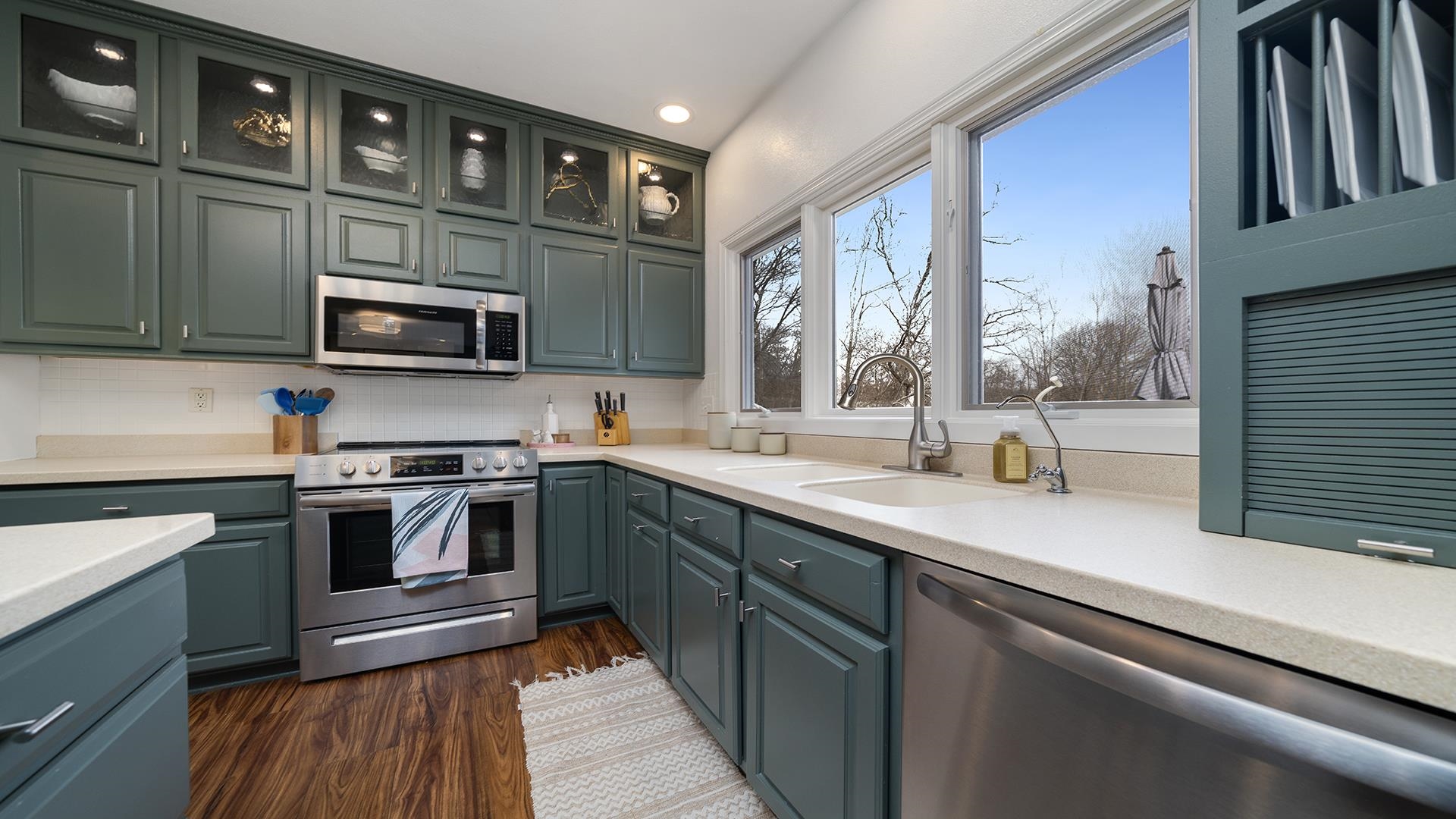 7676 Forest Way Roscoe, IL 61073 - Photo 12 of 56 a kitchen with stainless steel appliances granite countertop a sink stove and microwave