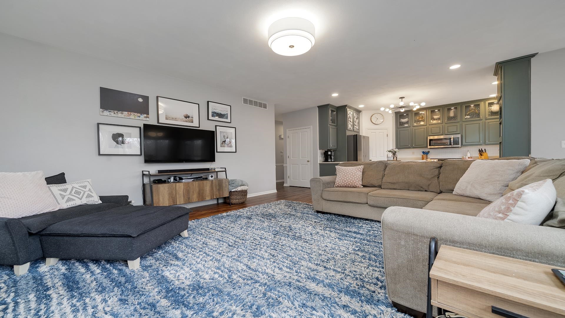 7676 Forest Way Roscoe, IL 61073 - Photo 23 of 56 a living room with furniture and a flat screen tv