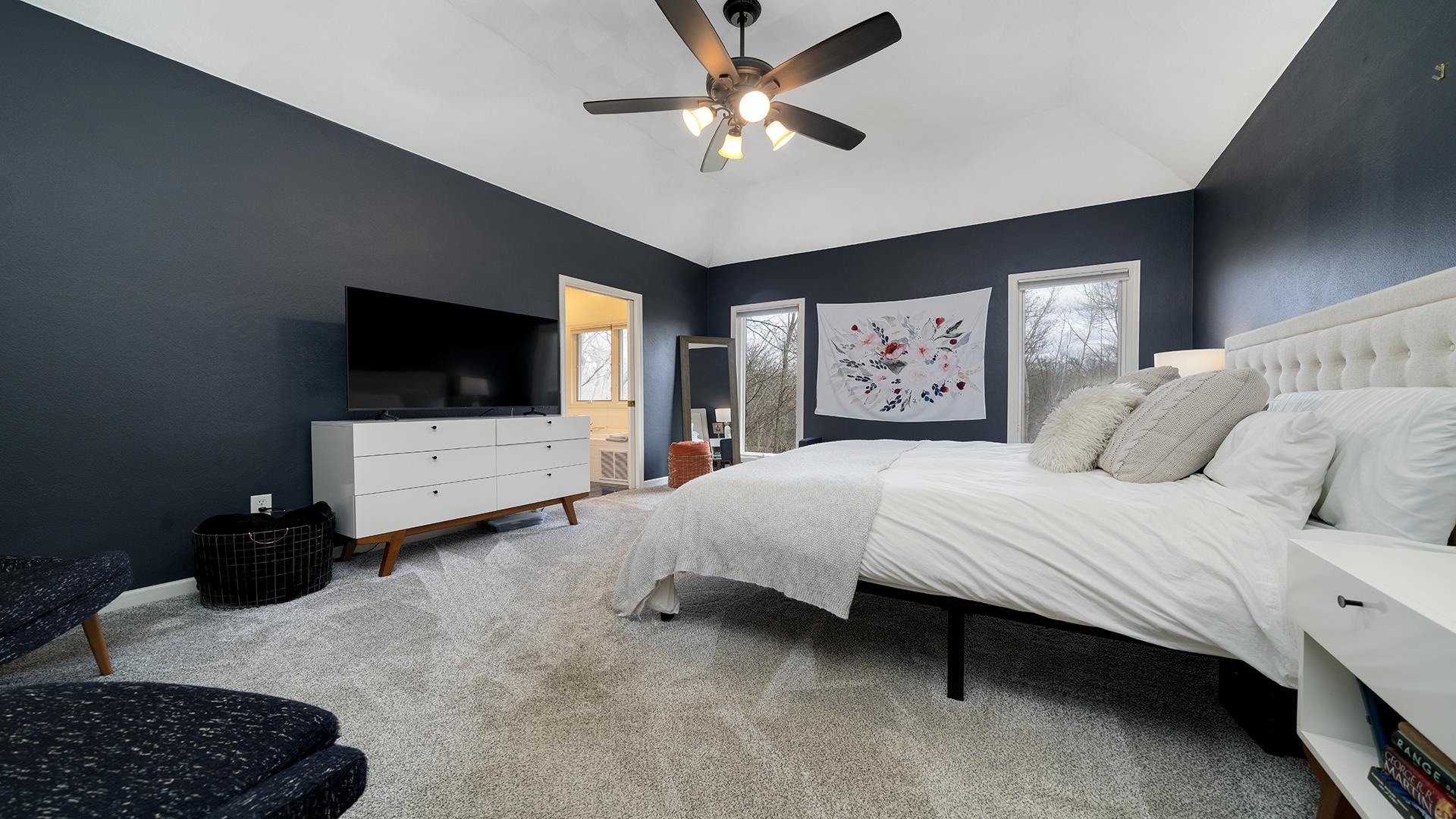 7676 Forest Way Roscoe, IL 61073 - Photo 27 of 56 a bedroom with a bed window and a flat screen tv