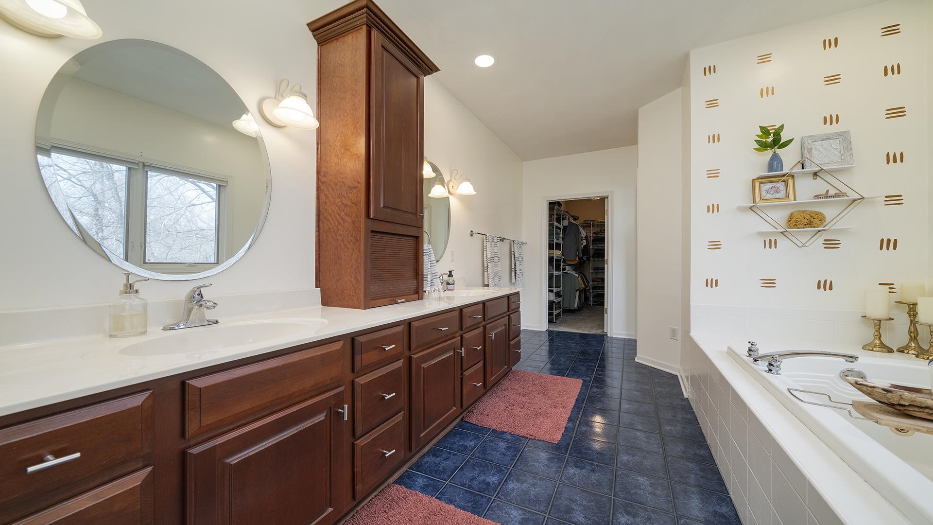 7676 Forest Way Roscoe, IL 61073 - Photo 28 of 56 a bathroom with a double vanity sink mirror and bathtub