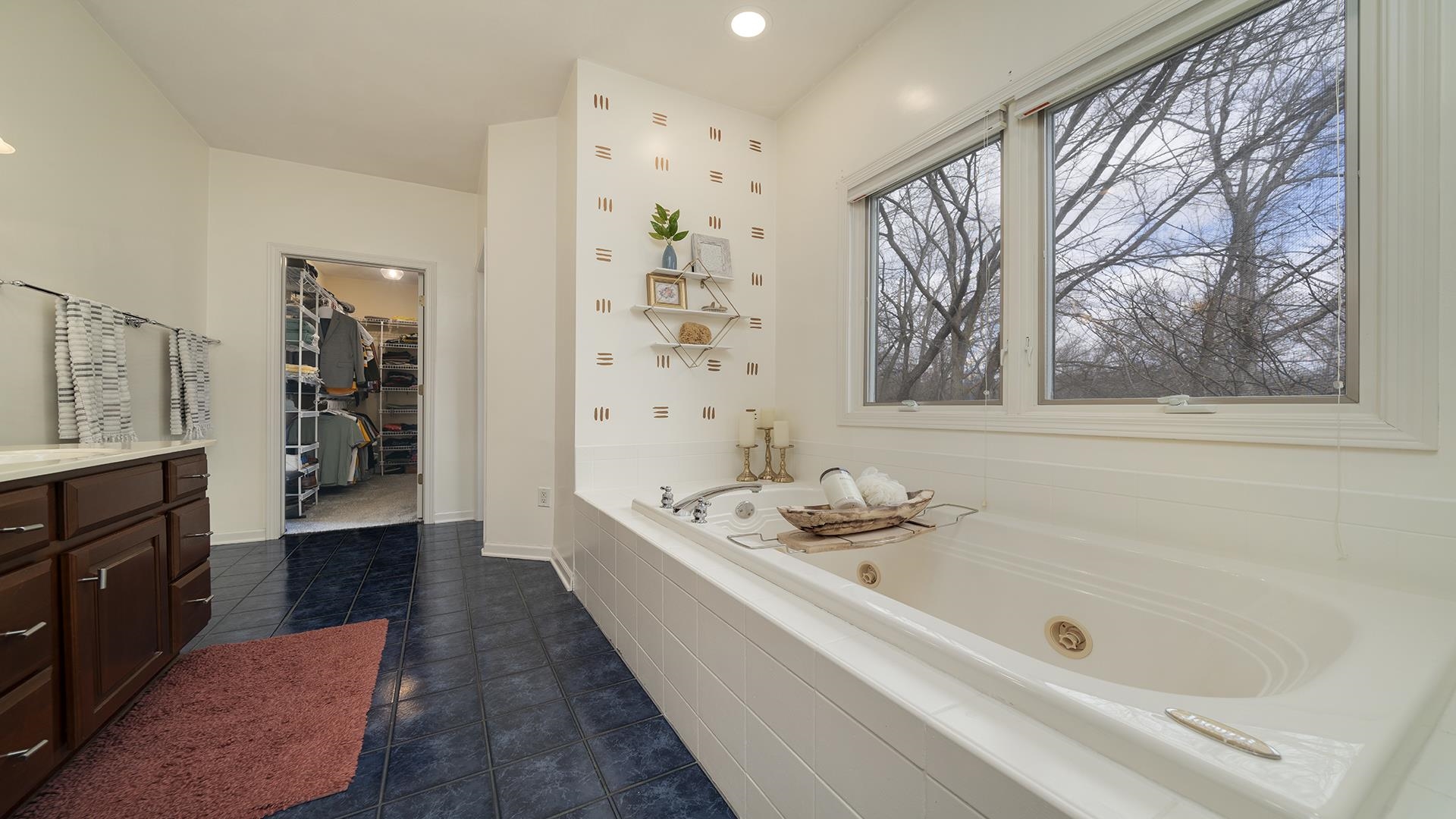 7676 Forest Way Roscoe, IL 61073 - Photo 29 of 56 a bathroom with a bathtub and a shower