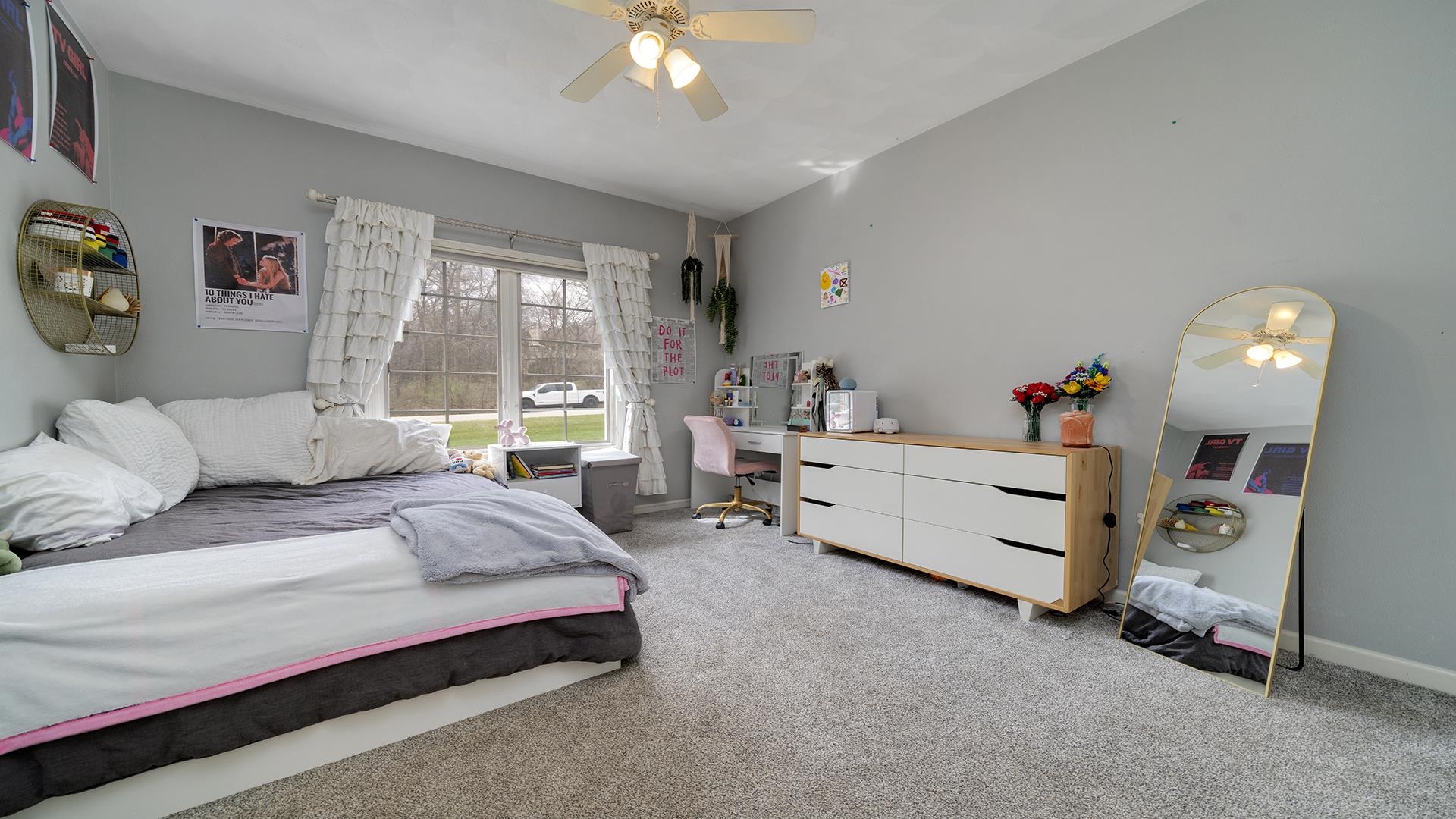 7676 Forest Way Roscoe, IL 61073 - Photo 30 of 56 a spacious bedroom with a bed and a chandelier