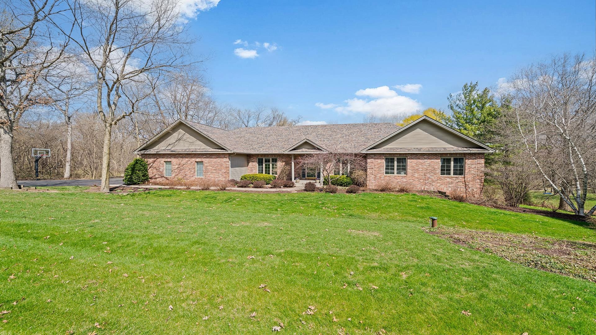 7676 Forest Way Roscoe, IL 61073 - Photo 3 of 56 a front view of a house with yard and green space