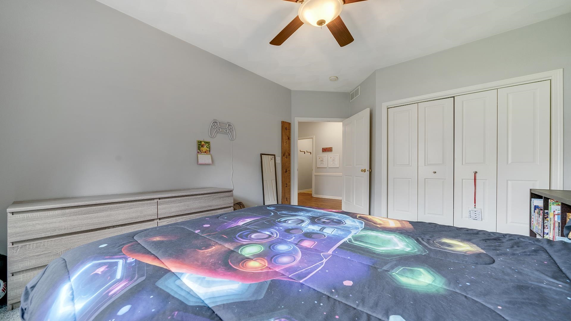 7676 Forest Way Roscoe, IL 61073 - Photo 34 of 56 a bedroom with a bed and a chandelier