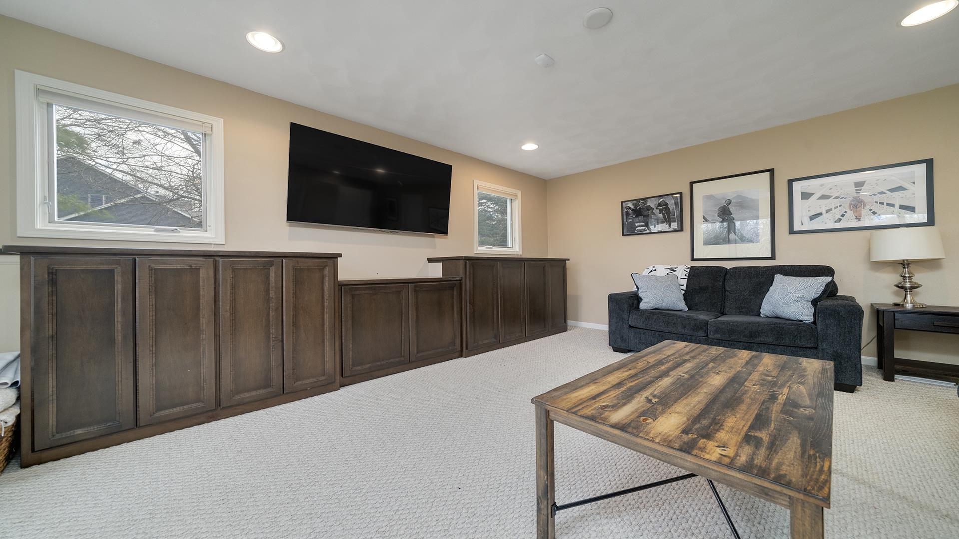 7676 Forest Way Roscoe, IL 61073 - Photo 39 of 56 a living room with furniture a flat screen tv and a window