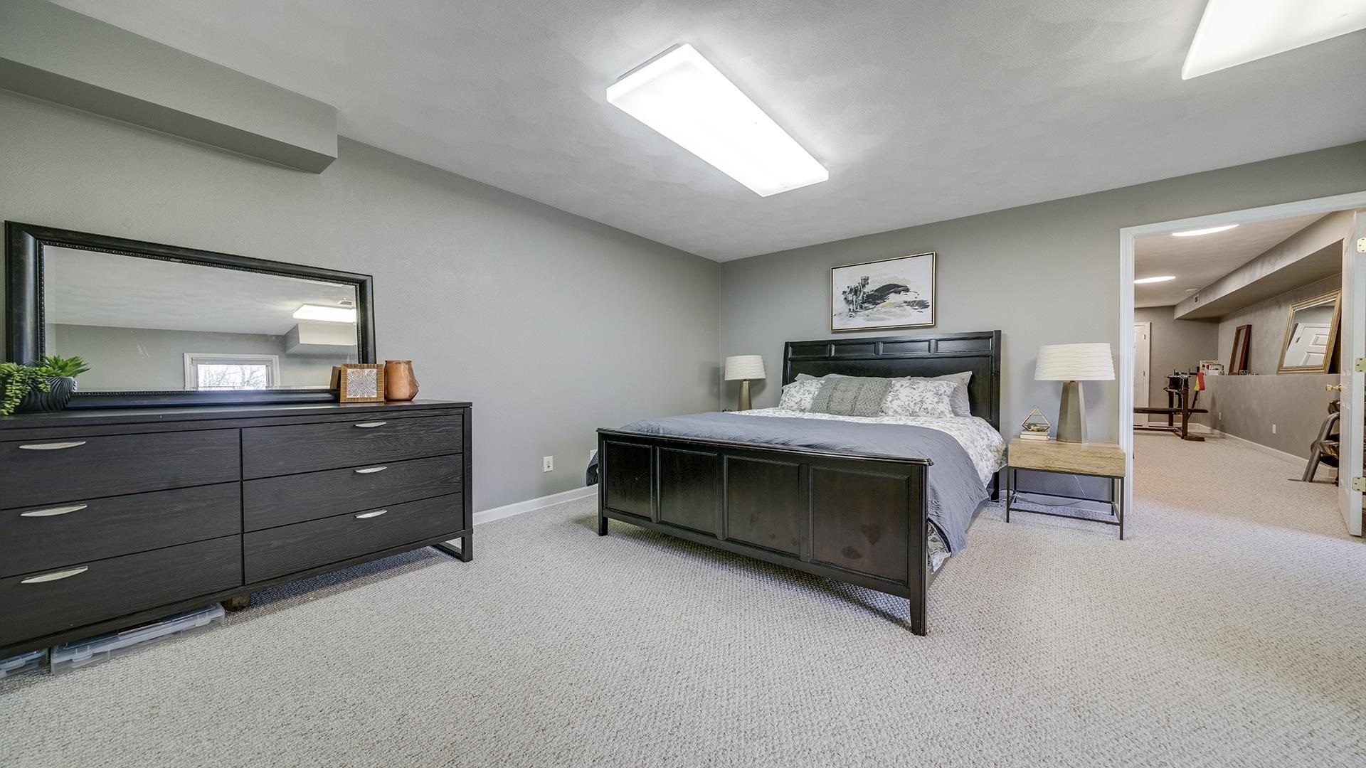 7676 Forest Way Roscoe, IL 61073 - Photo 42 of 56 a bedroom with a bed and a dresser in it