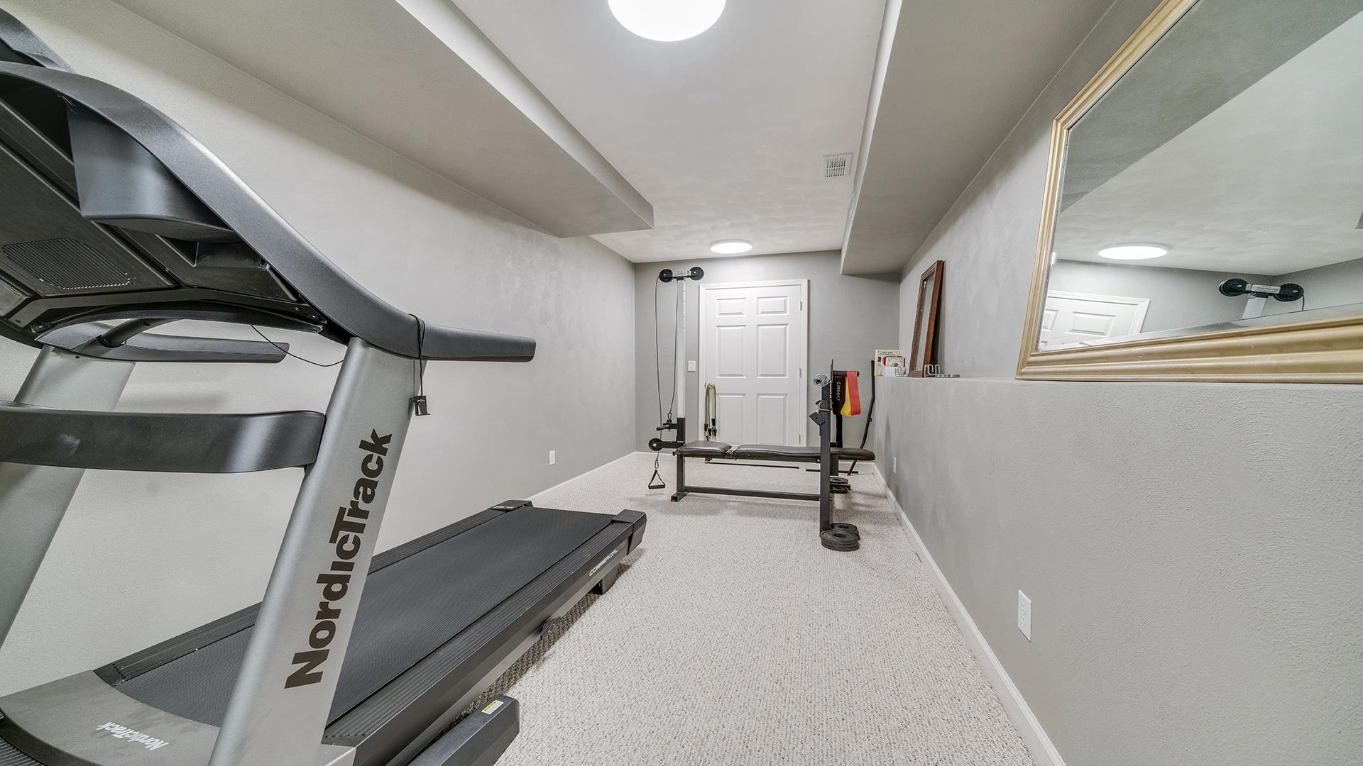 7676 Forest Way Roscoe, IL 61073 - Photo 46 of 56 a view of a room with gym equipment