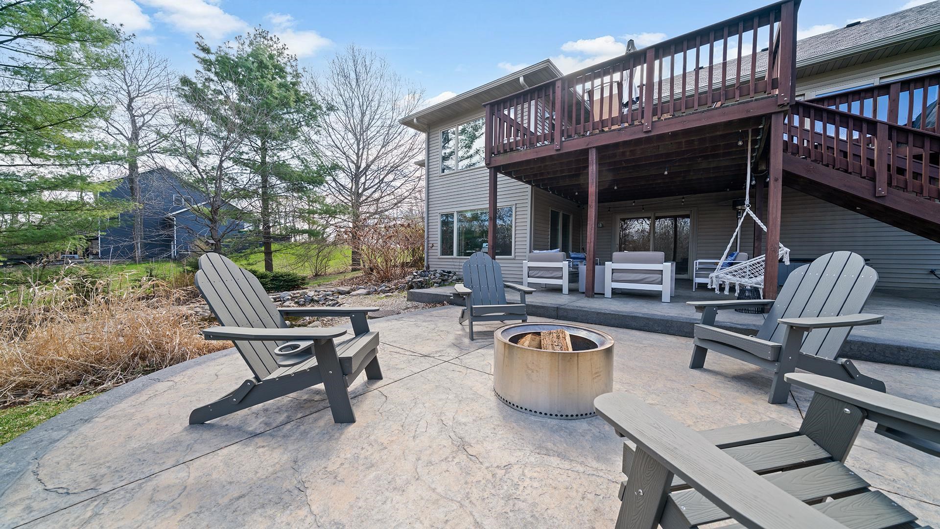 7676 Forest Way Roscoe, IL 61073 - Photo 49 of 56 a view of a patio with table and chairs and wooden fence