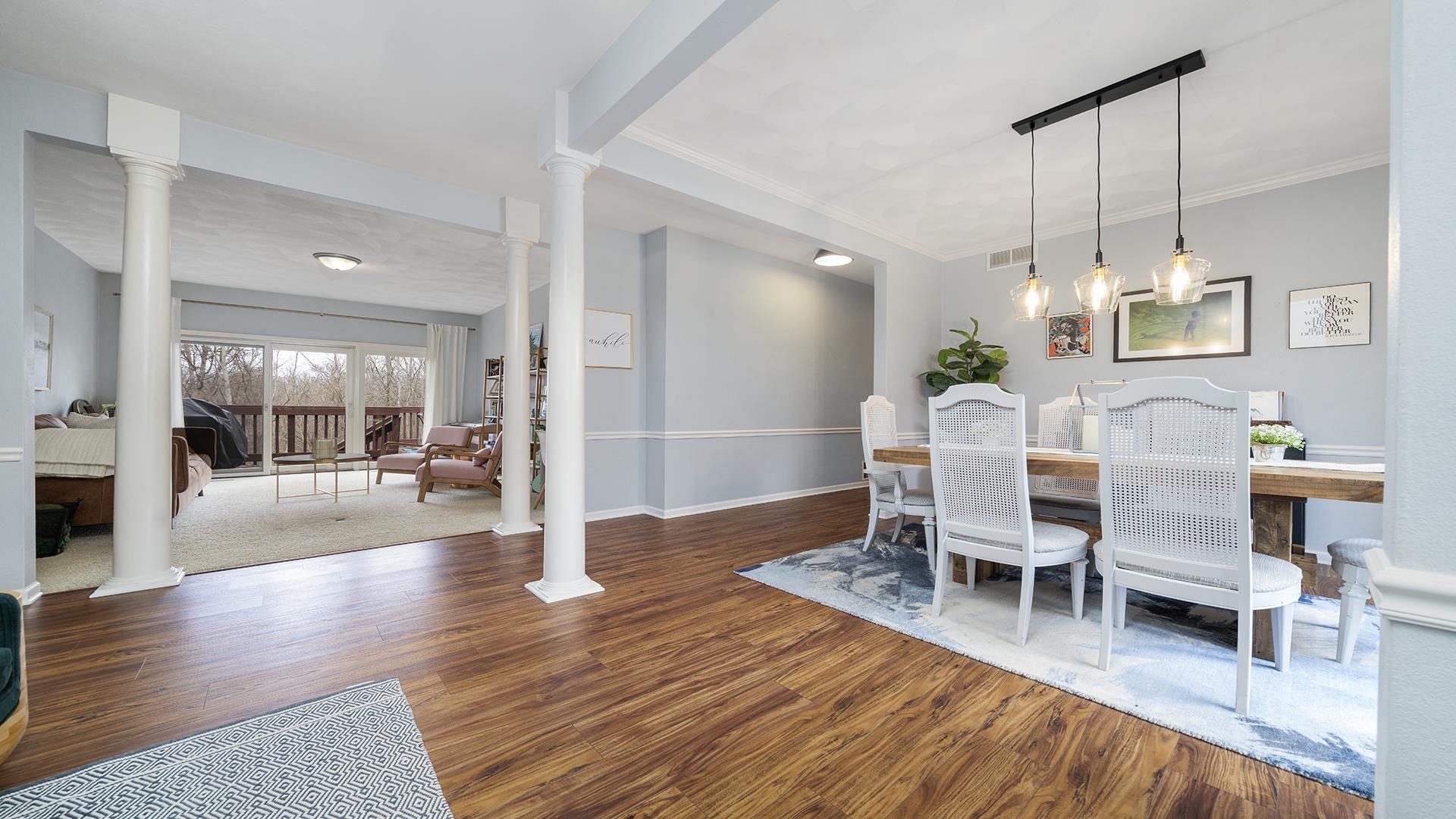 7676 Forest Way Roscoe, IL 61073 - Photo 7 of 56 a living room with furniture and a dining table with wooden floor